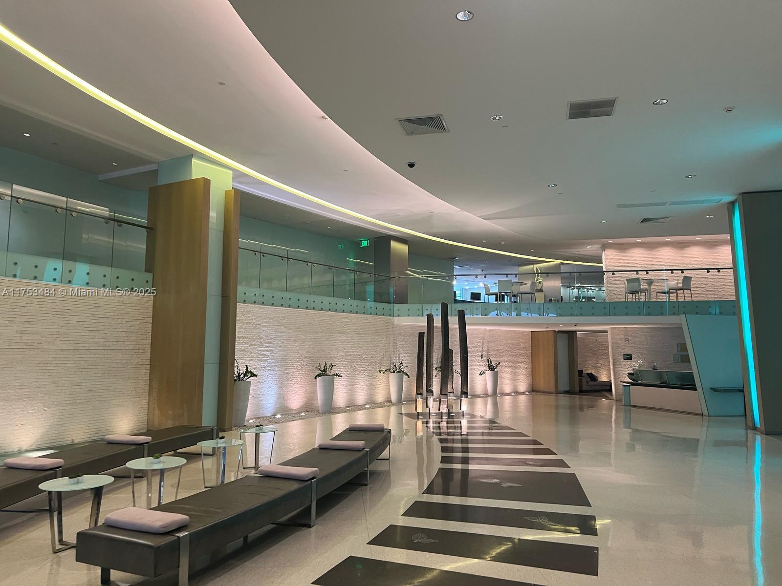 92 Southwest 3rd Street, Unit 2412 Miami, FL 33130 - Photo 12 of 14 a living room with couch and a potted plant