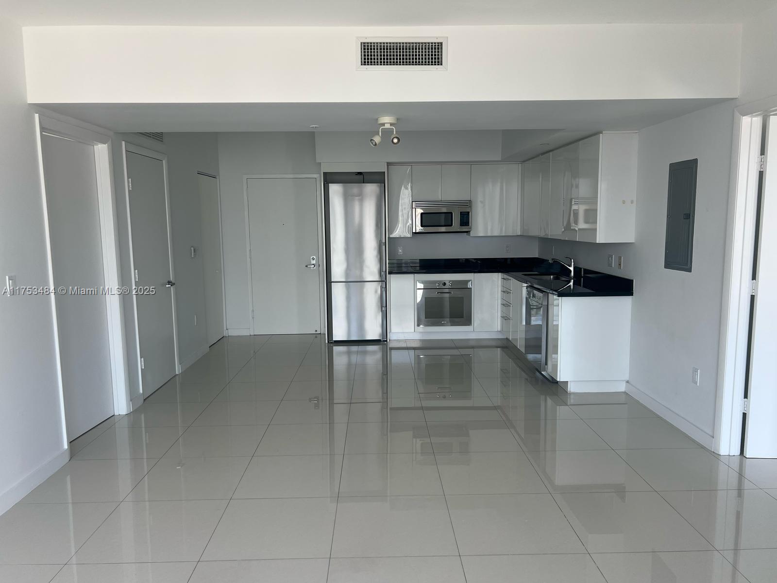 92 Southwest 3rd Street, Unit 2412 Miami, FL 33130 - Photo 3 of 14 a kitchen with stainless steel appliances a refrigerator and a stove
