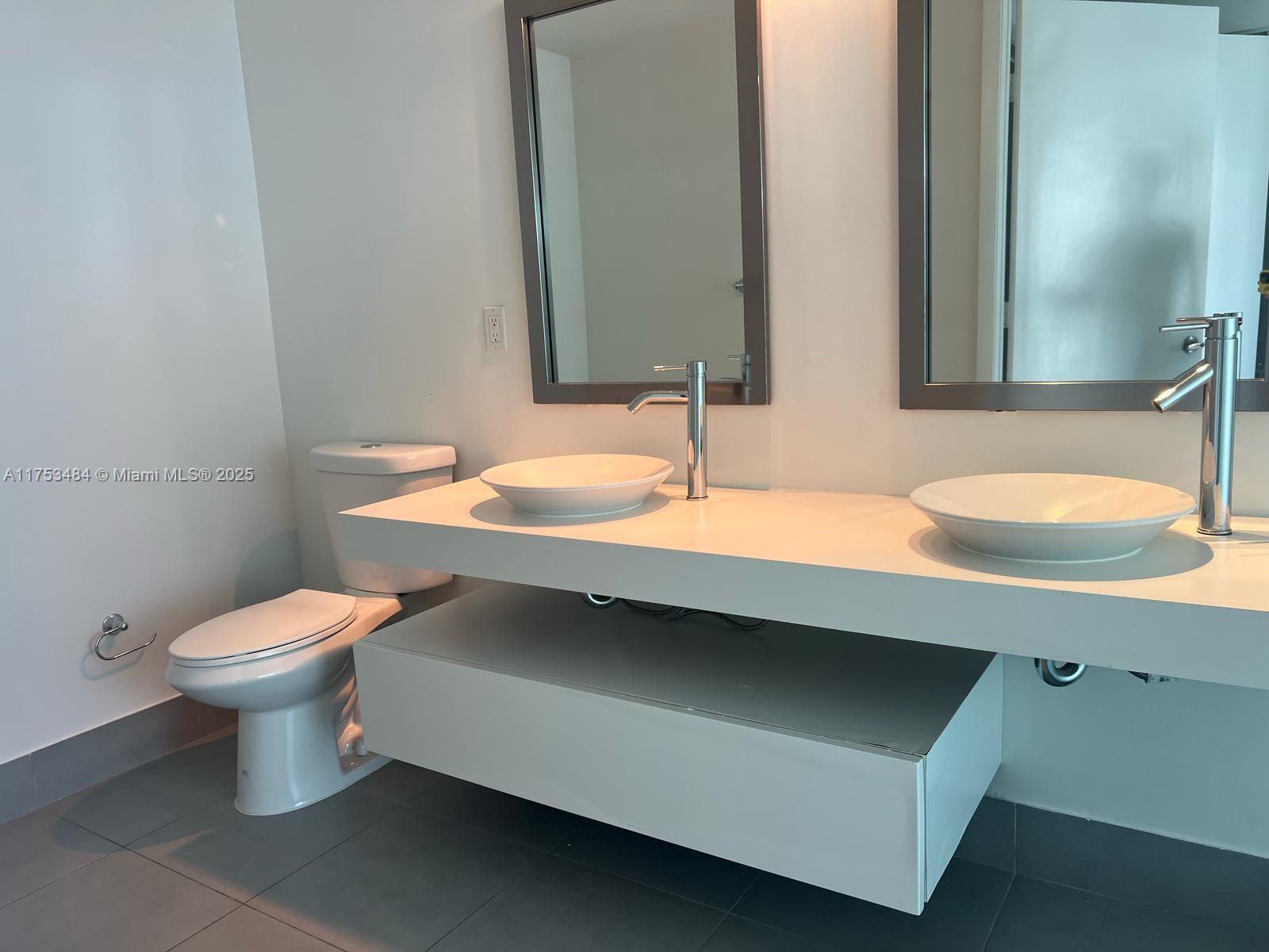 92 Southwest 3rd Street, Unit 2412 Miami, FL 33130 - Photo 9 of 14 a bathroom with a sink and a toilet