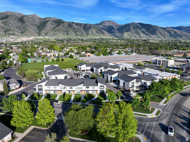 220 Spring Creek Parkway Providence, UT 84332 - Photo 17 of 17 Contemporary townhome community with striking mountain backdrop, featuring modern architecture, manicured landscaping, and expansive green spaces