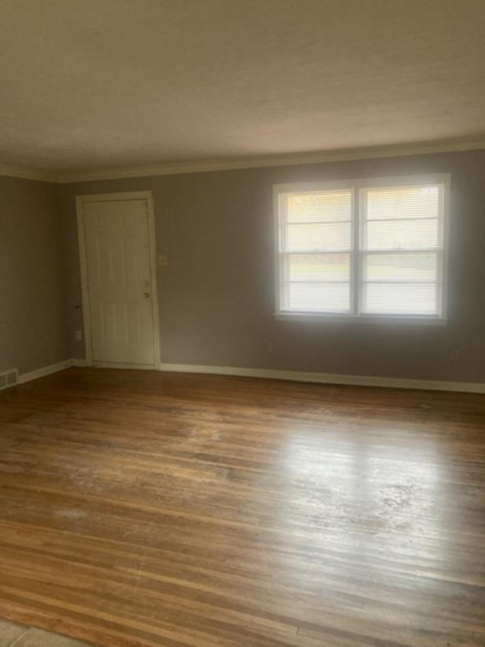 6729 Macon Road Memphis, TN 38134 - Photo 2 of 16 an empty room with wooden floor and windows