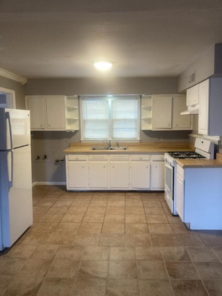 6729 Macon Road Memphis, TN 38134 - Photo 4 of 16 a kitchen with a cabinets a sink a window and stainless steel appliances