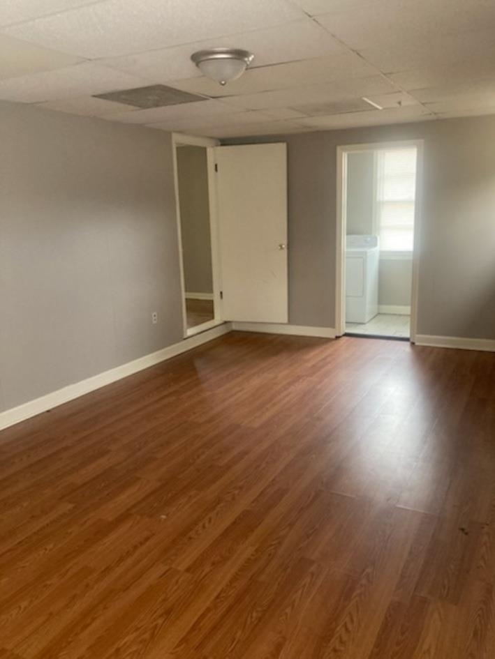 6729 Macon Road Memphis, TN 38134 - Photo 6 of 16 an empty room with wooden floor and windows