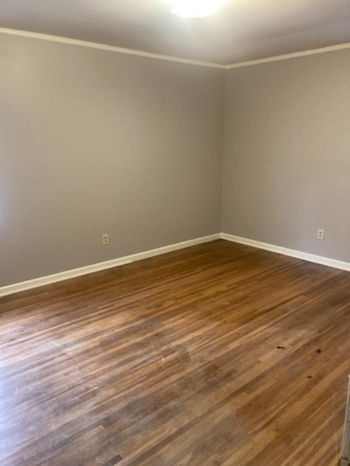 6729 Macon Road Memphis, TN 38134 - Photo 9 of 16 a view of an empty room with wooden floor and a window