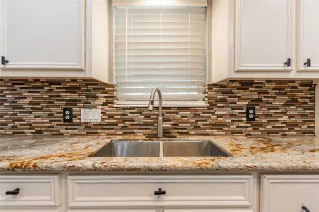 a kitchen with sink and cabinets