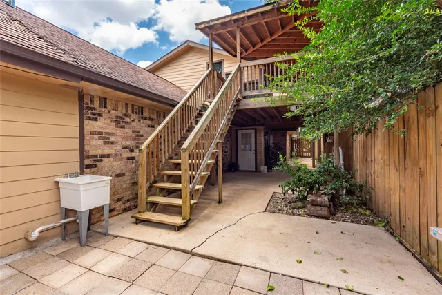 a view of a chair and tables in the patio with potted plants