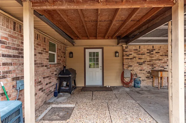 a view of a door and chair in the patio