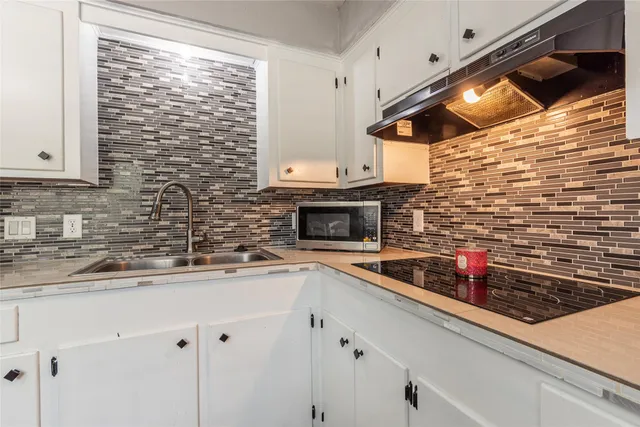 a kitchen with stainless steel appliances a sink and cabinets