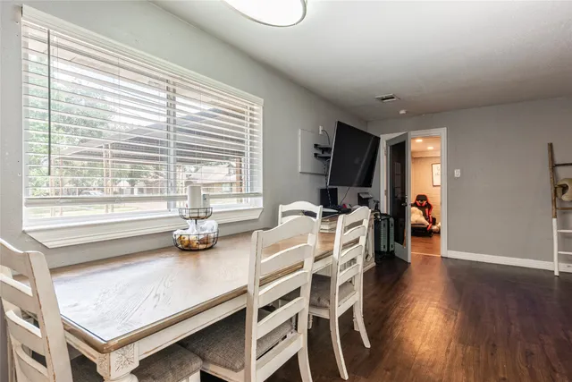 a dining room with furniture and wooden floor