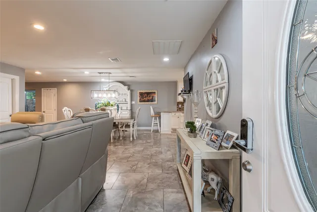 a living room with furniture a window and a clock