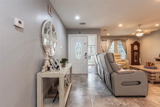 a living room with furniture a fireplace and a chandelier