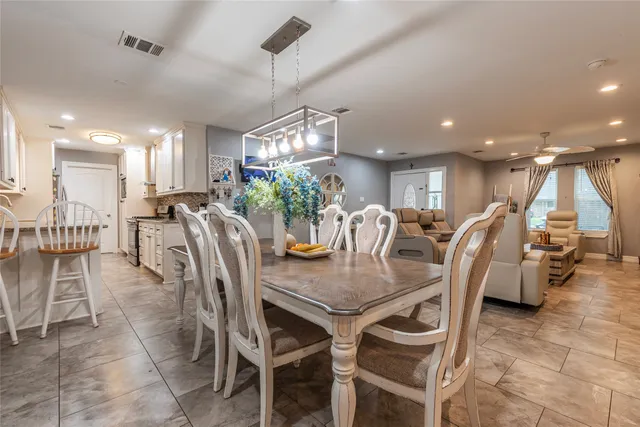 a view of a dining area with furniture and a chandelier