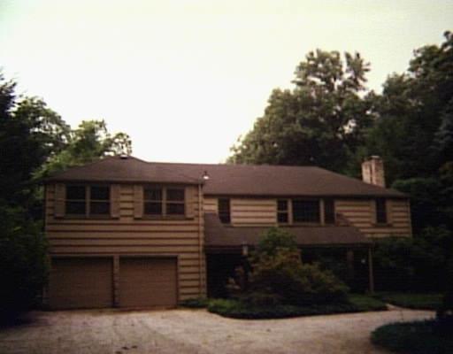 15 Rogues Ridge Road Weston, CT 06883 - Photo 1 of 1 a front view of a house with a yard