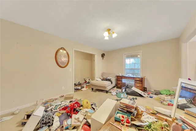 a living room with furniture and a mirror
