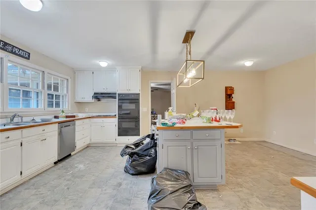 a kitchen that has a lot of cabinets in it