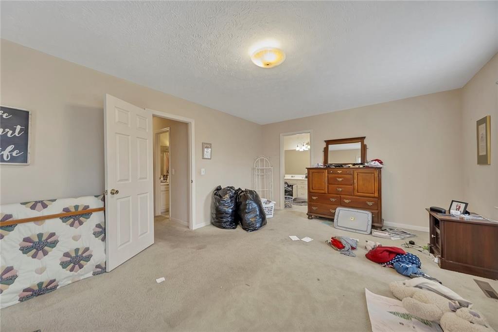 259 Holley Heights Jasper, GA 30143 - Photo 29 of 53 a bedroom with furniture and a chandelier