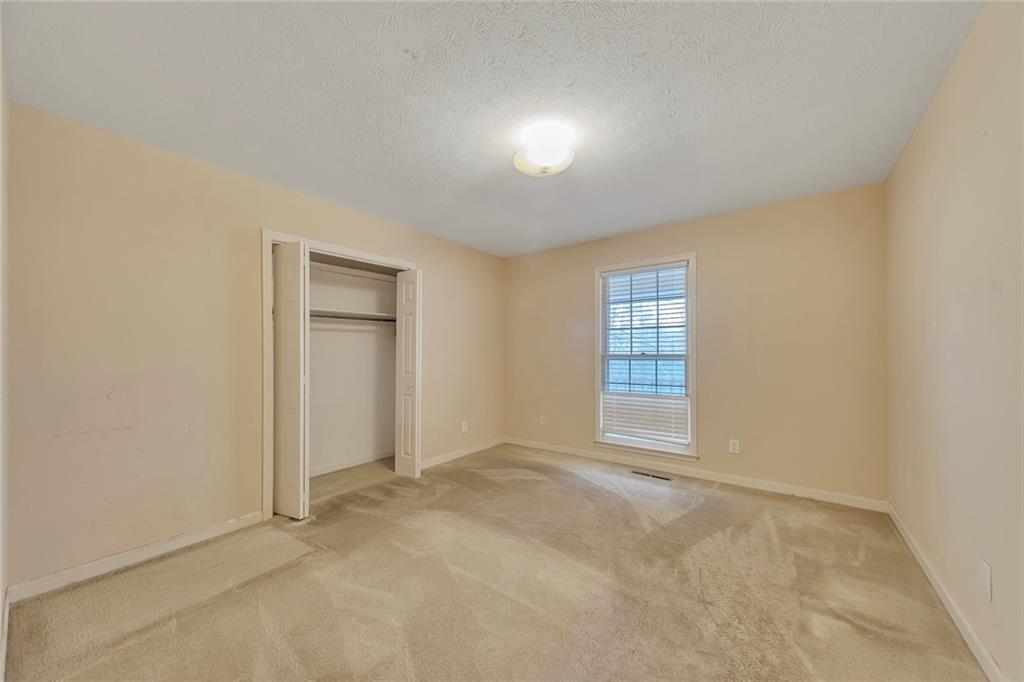 259 Holley Heights Jasper, GA 30143 - Photo 31 of 53 an empty room with windows and closet