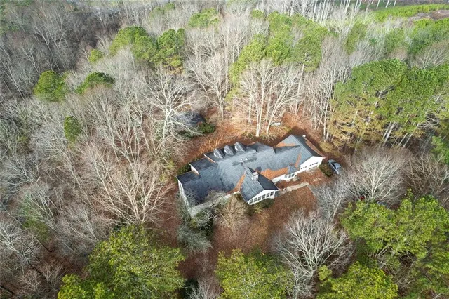 a backyard of a house with a yard and outdoor seating