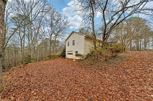 a white house that has a tree in front of it