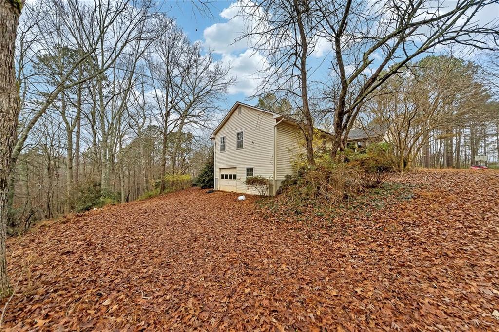 259 Holley Heights Jasper, GA 30143 - Photo 7 of 53 a white house that has a tree in front of it