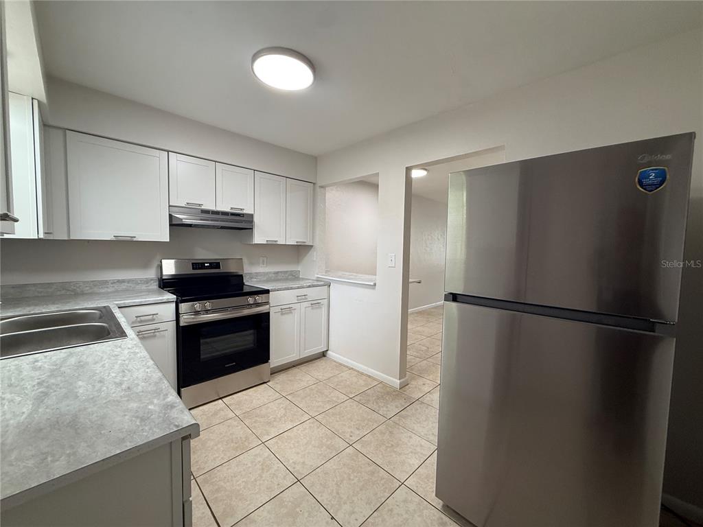 6030 Southwest 12th Place, Unit 2 Gainesville, FL 32607 - Photo 4 of 7 a kitchen with a refrigerator sink and stove