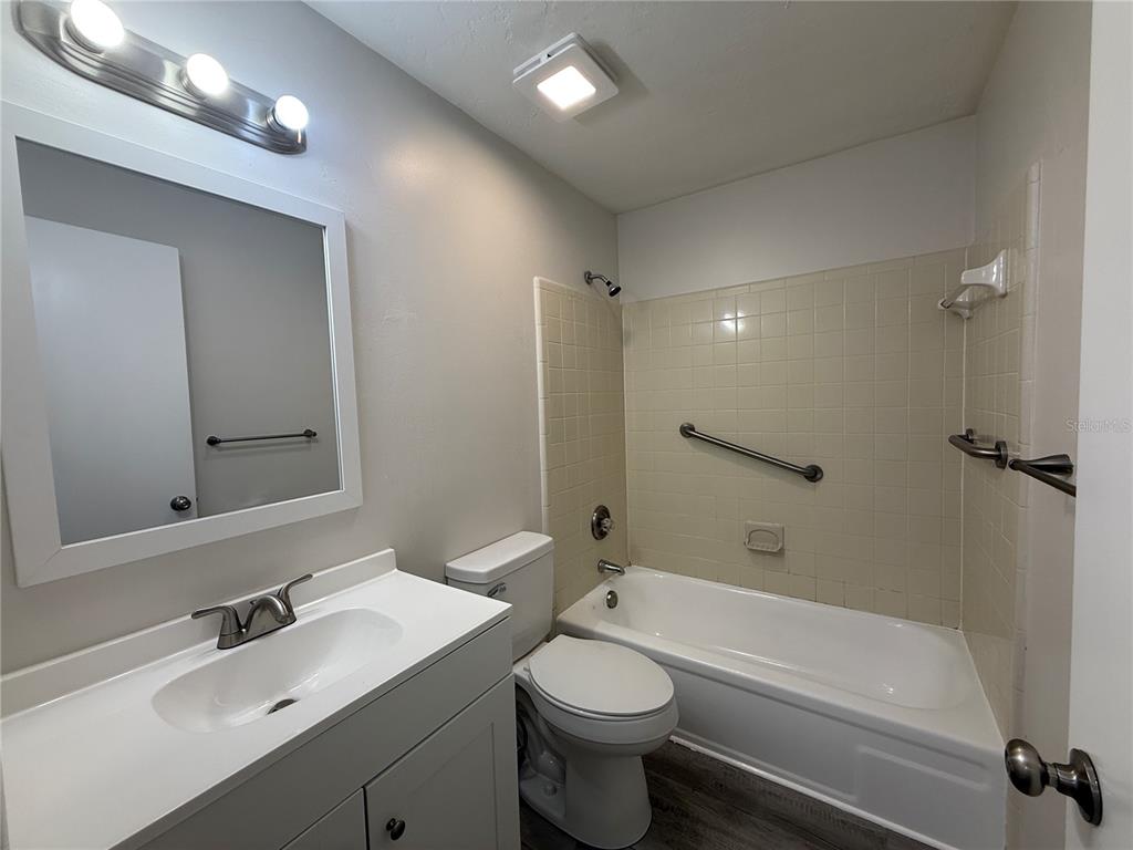 6030 Southwest 12th Place, Unit 2 Gainesville, FL 32607 - Photo 6 of 7 a bathroom with a sink a toilet and shower