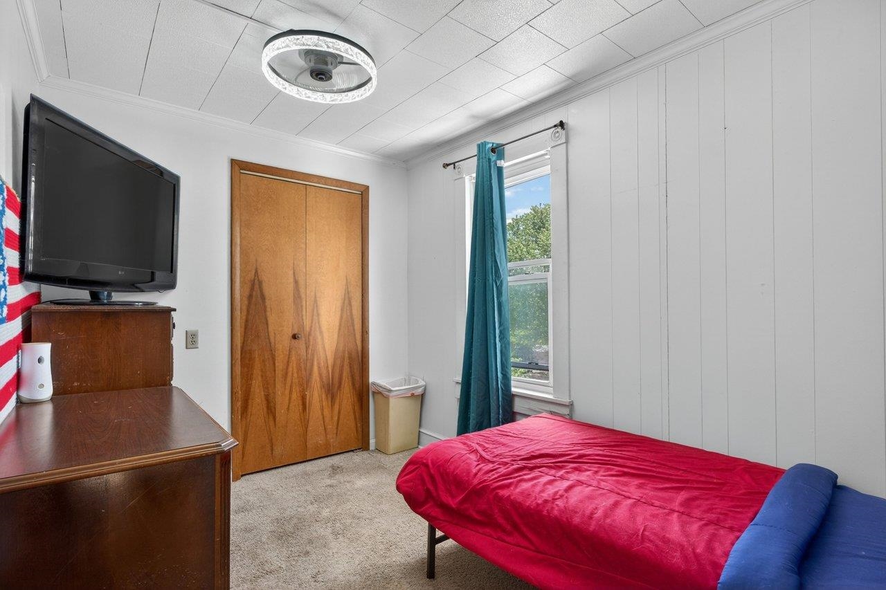 724 Newtown Road Elkton, VA 22827 - Photo 26 of 38 a bedroom with a bed and a flat screen tv