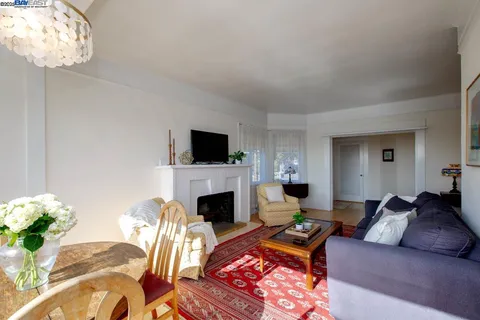 a living room with furniture a large window and a fireplace