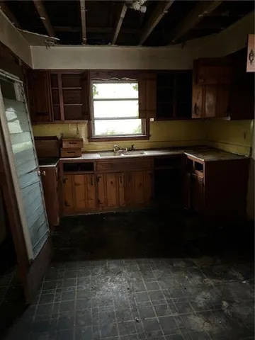 a kitchen with a sink a stove a microwave and cabinets