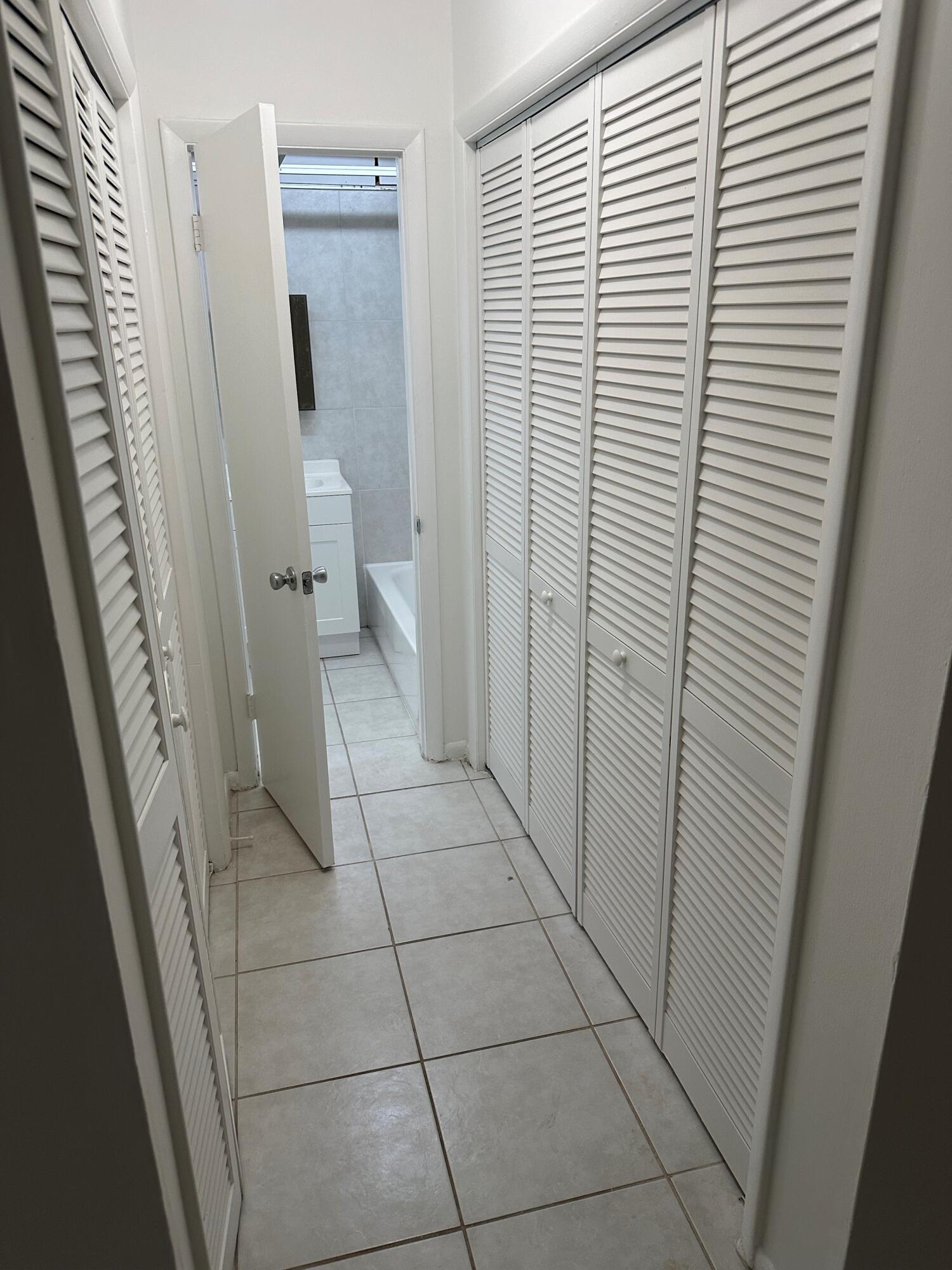 602 Northwest 13th Street, Unit 150 Boca Raton, FL 33486 - Photo 8 of 12 a view of a bathroom with white door