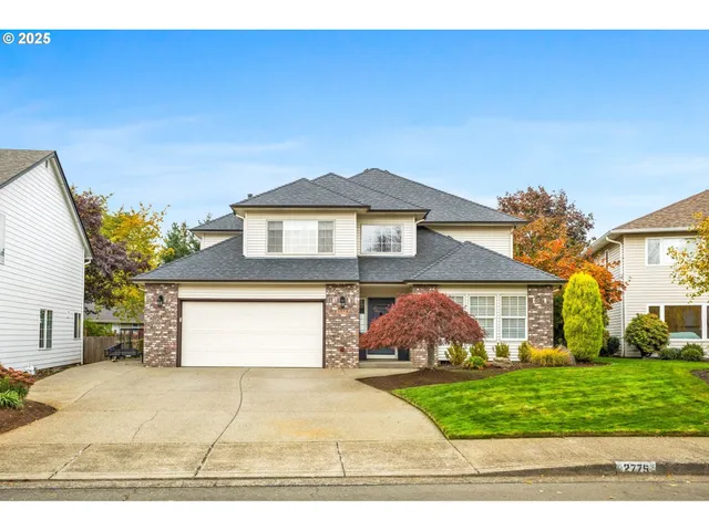 a front view of a house with a yard and garage