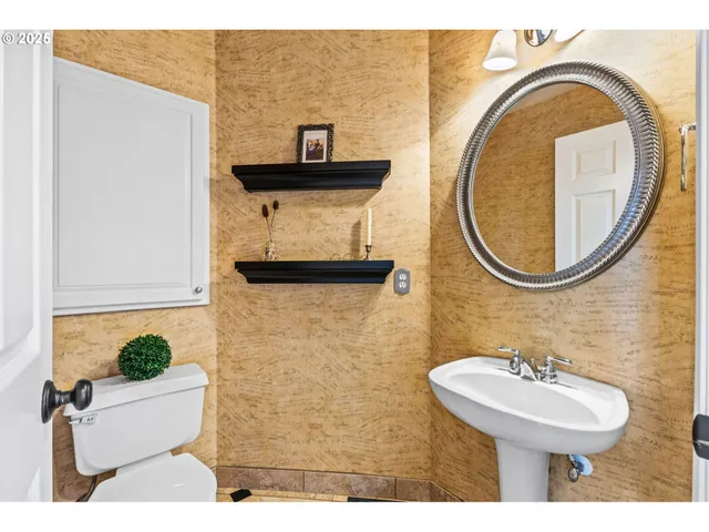 a bathroom with a sink a mirror and a toilet