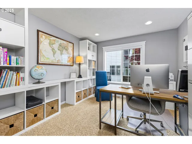 a workspace with furniture a window and bookshelf