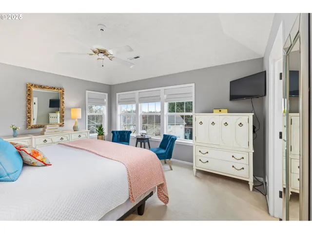 a bedroom with a bed and flat screen tv