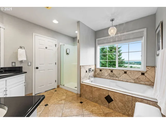 a bathroom with a tub sink and mirror