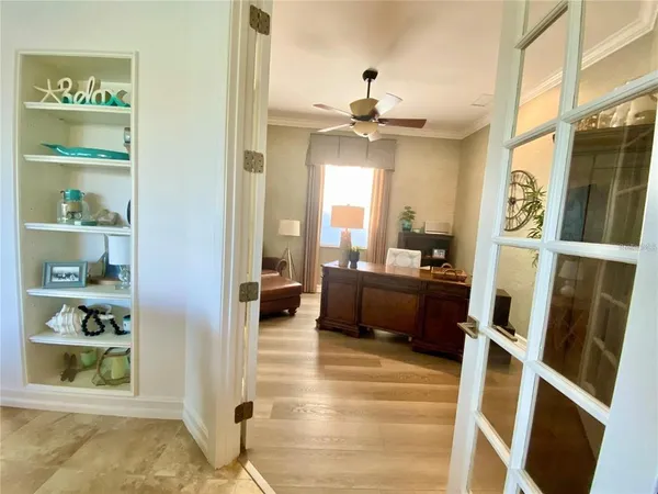 a living room with furniture a flat screen tv and a large window