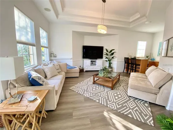 a living room with furniture a large window and a fireplace