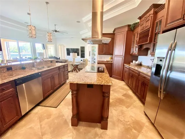 a large kitchen with a large counter top appliances and cabinets
