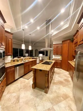 a living room with furniture and kitchen view