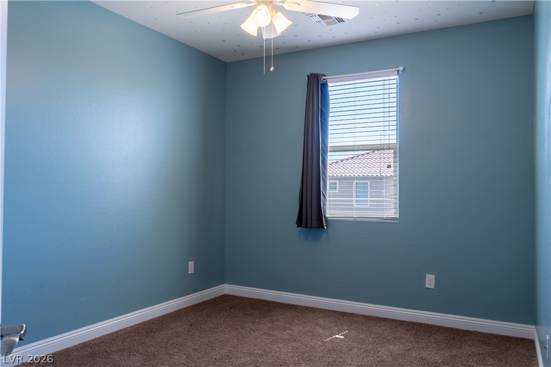 11045 Elk Sands Road Las Vegas, NV 89179 - Photo 58 of 67 Plush carpeting and classic baseboards anchor this versatile bedroom space.