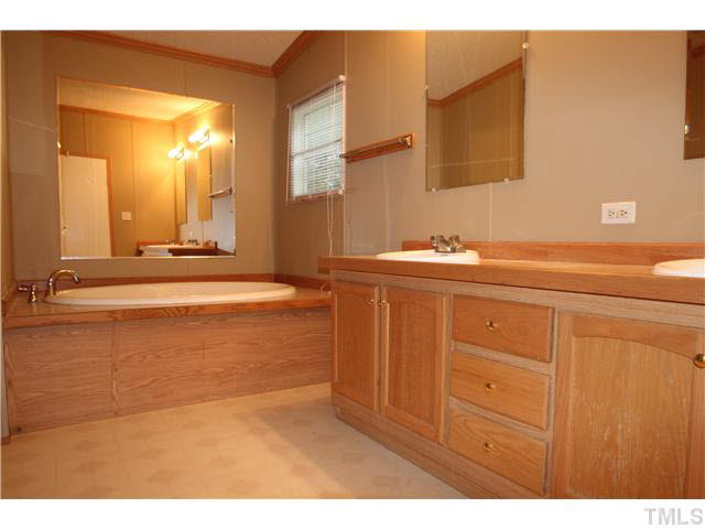 214 Jb Lane Roxboro, NC 27574 - Photo 9 of 16 Master bedroom with dual vanities, garden tub and separate shower