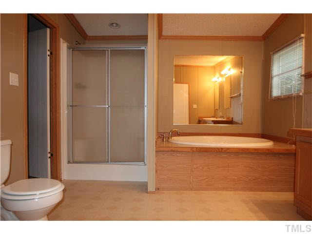 214 Jb Lane Roxboro, NC 27574 - Photo 10 of 16 Master bedroom with dual vanities, garden tub and separate shower