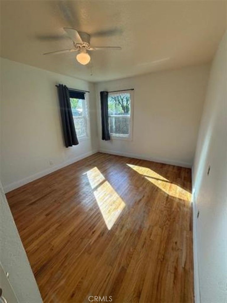 1517 Tehama Street Corning, CA 96021 - Photo 3 of 7 wooden floor in an empty room with a window