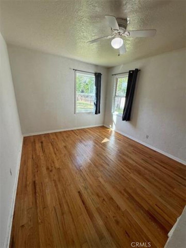 1517 Tehama Street Corning, CA 96021 - Photo 4 of 7 wooden floor in an empty room with a window
