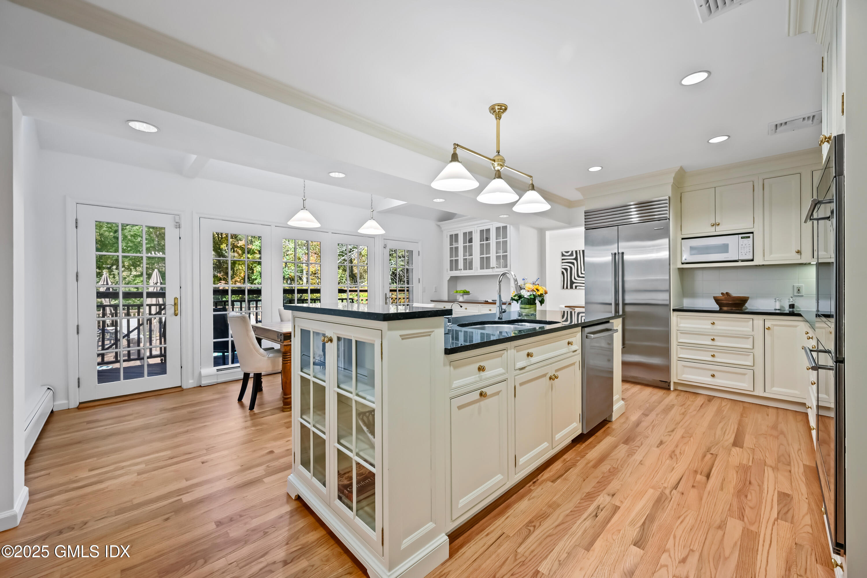 38 Bedford Road Greenwich, CT 06831 - Photo 10 of 32 a kitchen with stainless steel appliances granite countertop a lot of cabinets and wooden floor
