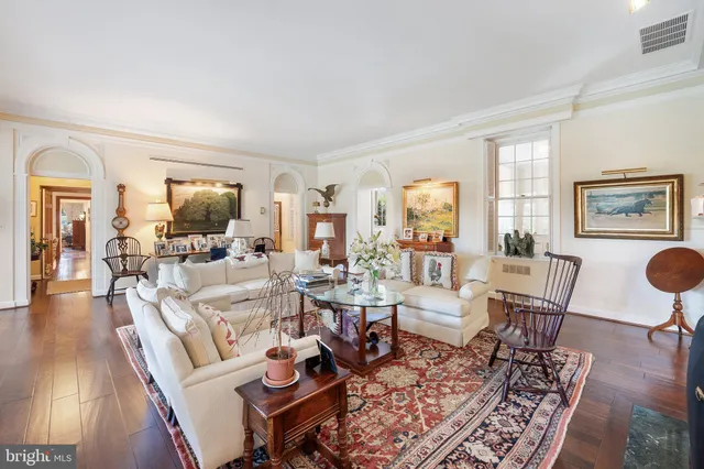 a living room with furniture a fireplace and a large window