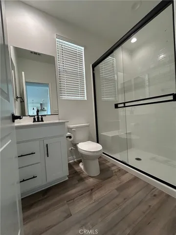 a bathroom with a double vanity sink toilet and shower