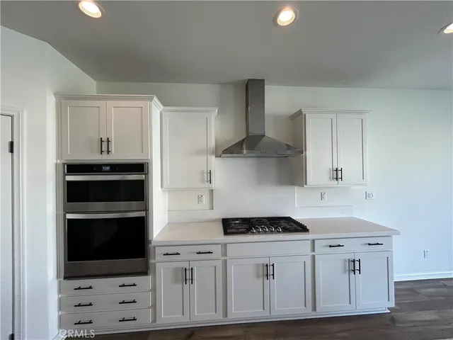 a kitchen with granite countertop a stove and a cabinets