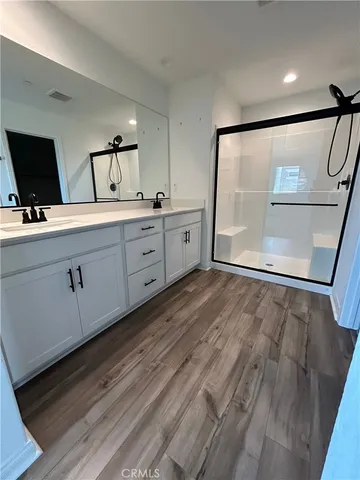 a spacious bathroom with a double vanity sink and a mirror
