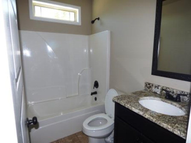 211 Timber Ridge Boulevard Byron, GA 31008 - Photo 12 of 31 a bathroom with a granite countertop sink toilet and shower